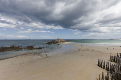 View of beach against cloudy sky