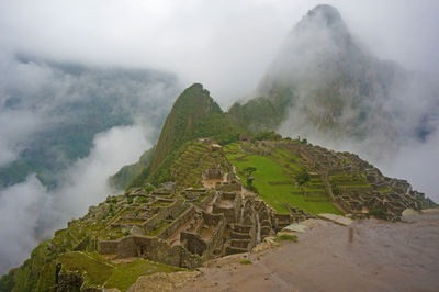 High angle view of historic machu picchu ruins in foggy weather