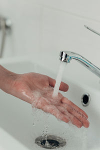 Close-up of washing hands in sink