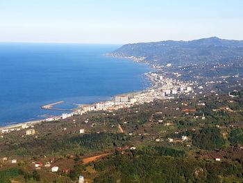 High angle view of buildings by sea against sky