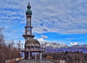 Low angle view of built structure against cloudy blue sky