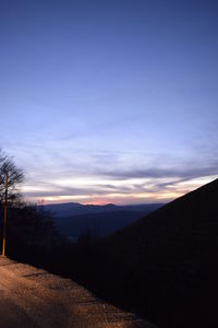 Scenic view of silhouette field against sky during sunset