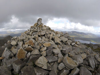 Stack of rocks on mountain against sky