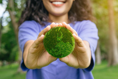 Close-up of woman holding plant