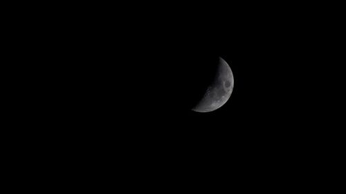 Low angle view of half moon against sky at night