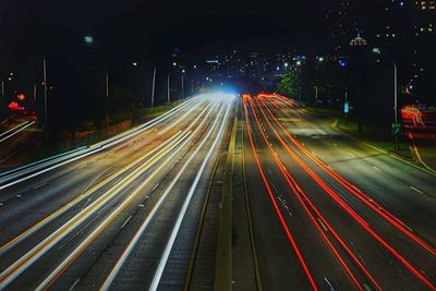 Blurred motion of traffic lights on road at night