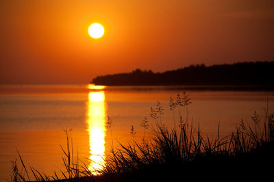 Scenic view of sea against romantic sky at sunset