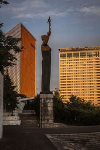 Statue against sky in city