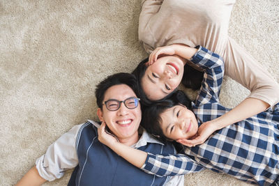 Portrait of happy friends lying on the floor