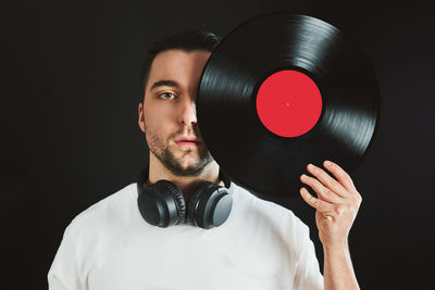 Music. man holding vinyl record covering face. vintage music style. turntable disk. classic audio