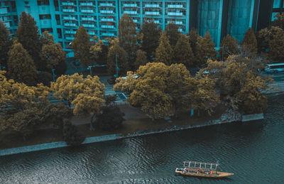 High angle view of boat moored on river in city