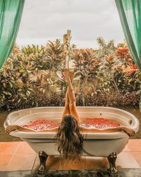 Rear view of woman in bathtub