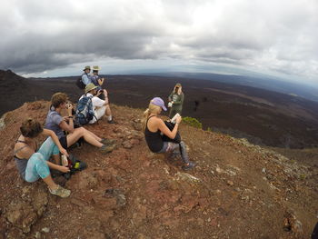 People relaxing on barren landscape