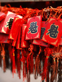 Close-up of red bell hanging in temple