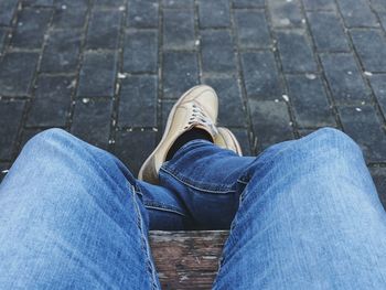 Low section of man sitting on bench