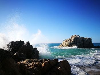 Scenic view of sea against clear blue sky