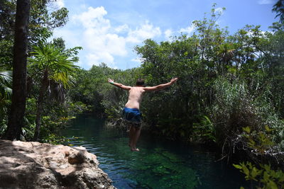 Woman jumping on pond