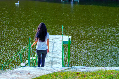 Rear view of woman standing in water