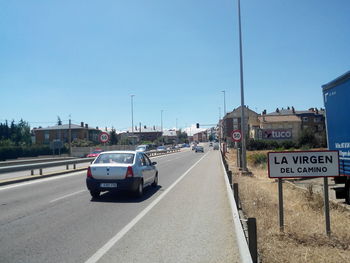 Road against clear blue sky