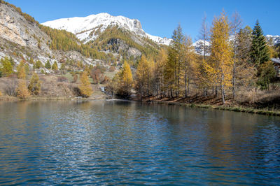 Scenic view of lake and mountains against sky