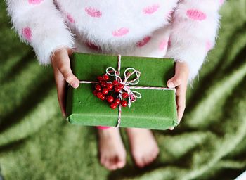 Low section of girl holding gift