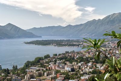 Scenic view of sea and mountains against sky