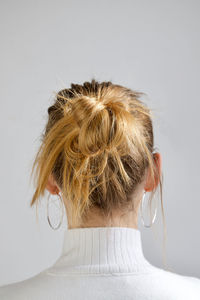 Close-up portrait of woman against white background