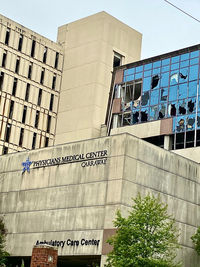 Low angle view of text on building against sky