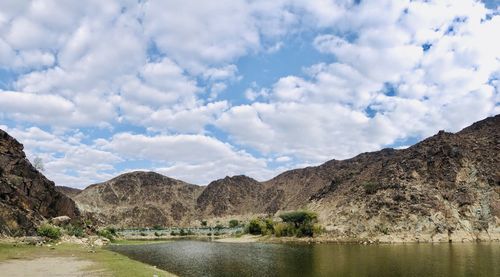 Scenic view of lake and mountains against sky