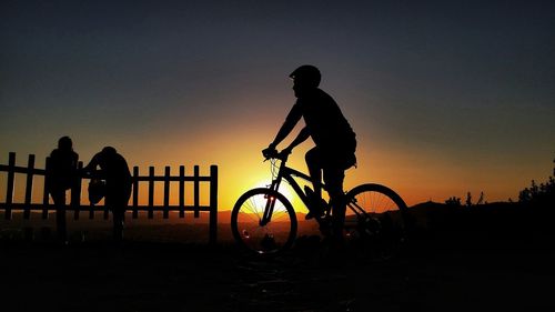 Silhouette people at sunset