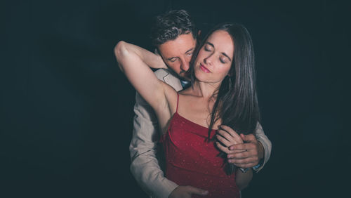 Romantic couple against black background