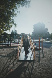 Rear view of woman on walkway