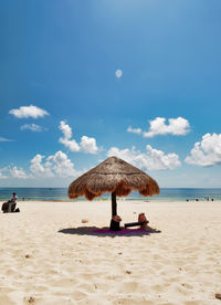 Lifeguard hut on beach against sky