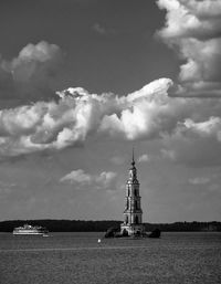 Flooded belfry amidst volga river against cloudy sky