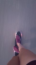 Low section of woman standing on tiled floor