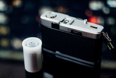 Close-up of vintage camera with reel box on table