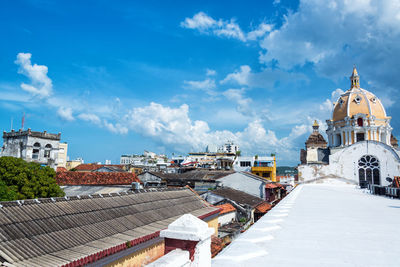 San pedro claver church amidst buildings against cloudy sky