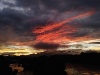 Dramatic sky over silhouette landscape during sunset