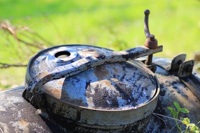 Close-up of rusty metal on field