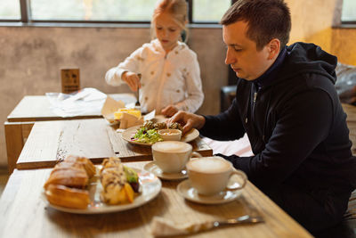 Midsection of man having food in restaurant