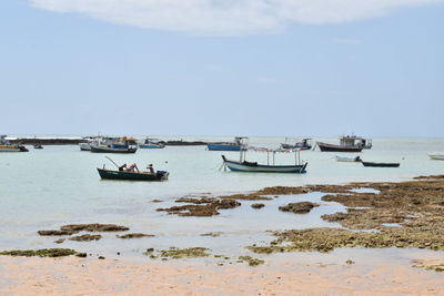 Boats in sea against sky