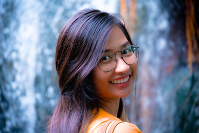 Close-up portrait of smiling young woman