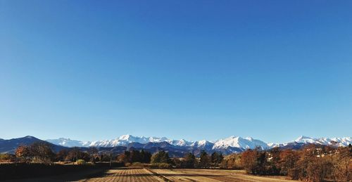 Scenic view of mountains against clear blue sky