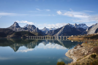 Scenic view of lake and mountains against sky