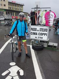 Man with bicycle sign in city