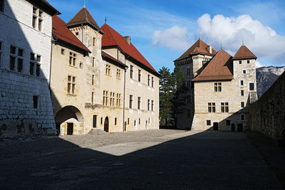 Street amidst buildings in town against sky