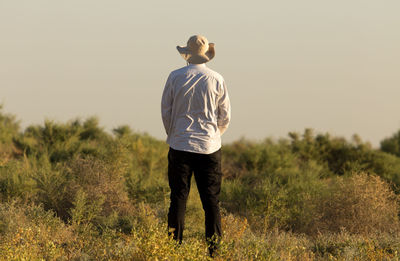 Rear view of man standing on field