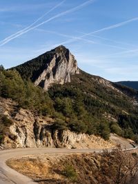 Scenic view of mountains against blue sky