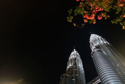 Low angle view of illuminated building against sky at night