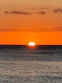 Scenic view of sea against romantic sky at sunset